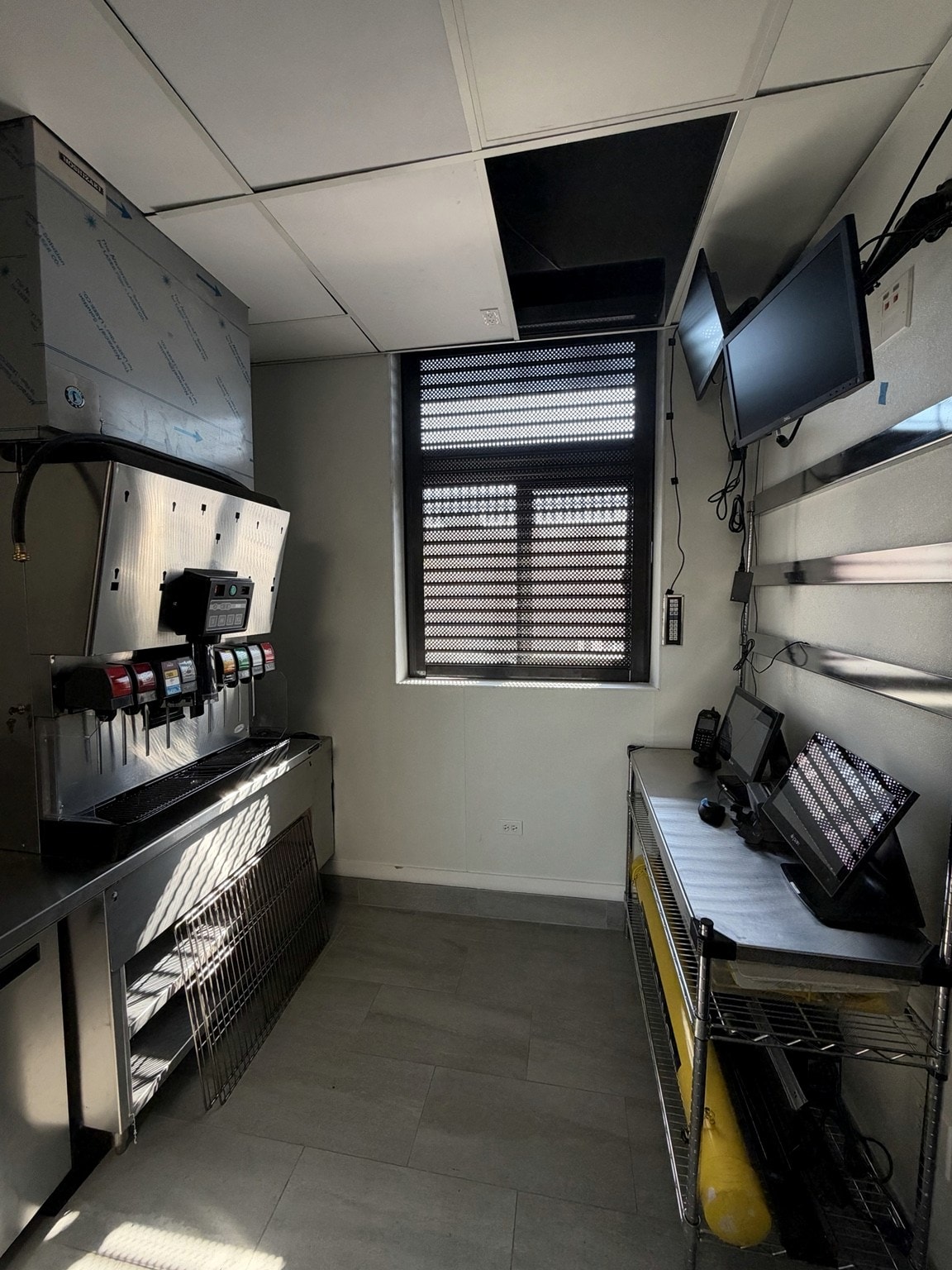 Drive-through service area with beverage dispensers and order monitors